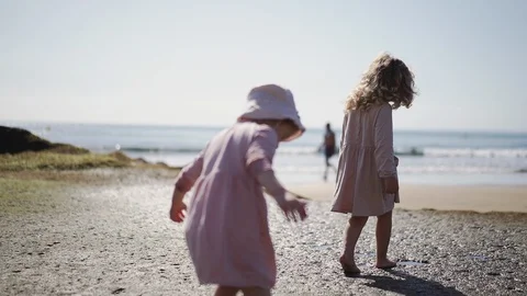 A child plays on the beach ocean in a puddle. Sunny day. Travel to the sea. Stock Footage 128142889