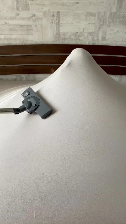 The child plays on the bed under the sheet, imitating a ghost. Stock Footage 141657071