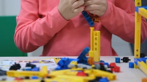 Child plays with a builder kit Video stock 80430274
