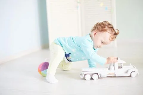 Child plays with a car in the studio Stock Photos