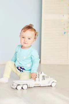 Child plays with a car in the studio Stock Photos