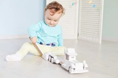 Child plays with a car in the studio Stock Photos