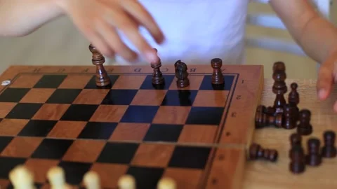 A child plays chess. Children at isolation learn remotely a game of chess. Video stock 140367952