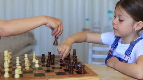 A child plays chess. Children at isolation learn remotely a game of chess. Video stock 140368853