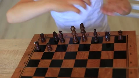 A child plays chess. Children at isolation learn remotely a game of chess. Stock Footage 140369986