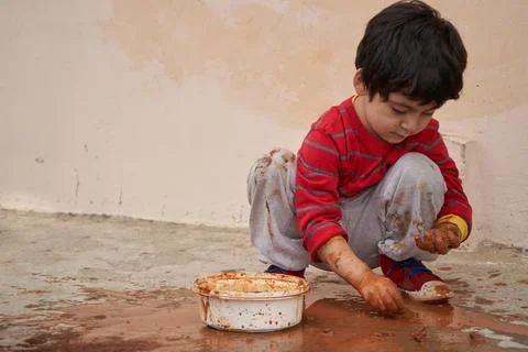 Child plays with clay while making figures Stock Photos