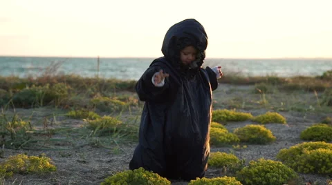 The child plays on the coast of cold ecologically dirty sea Stock Footage 63473175