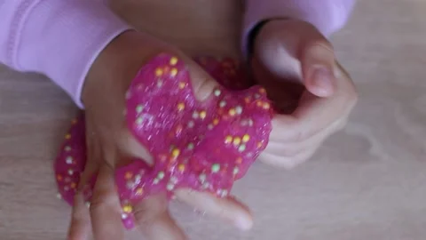 Child plays with colored slime on the table. Child development concept Stock Footage 221330713