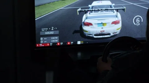 Child plays in a computer game driving a car in game club Video stock 63762667