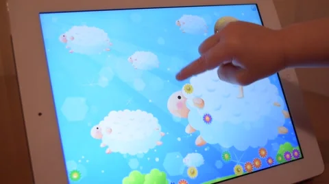A child plays a computer game on a tablet iPad Stock-Footage 60223182