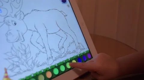 A child plays a computer game on a tablet iPad Stock-Footage 60223681