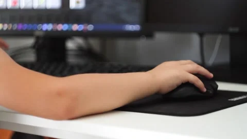 The child plays computer games. The boy at the PC monitor. A little boy plays a Stock Footage 209788409