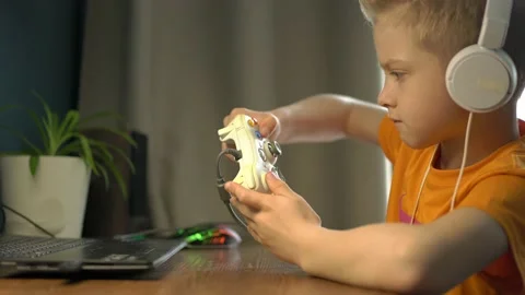 The child plays computer games at home. The child is addicted to computer games Stock Footage 194468786