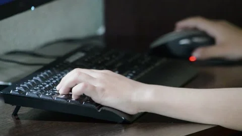 The child plays on the computer. Hands Stock Footage 132754148