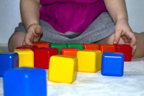 The child plays in cubes, the development of the child. Stock Photos