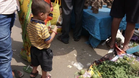 Child-plays-with-custard-apple-at-busy-market Stock Footage 95455705