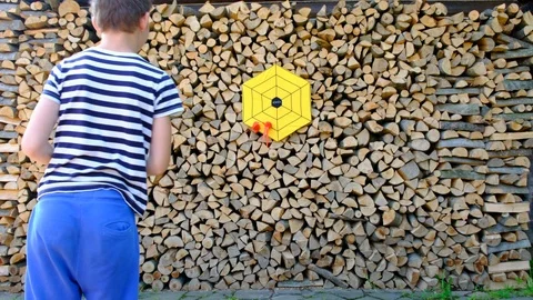 The child plays the darts game Stock Footage 102598613