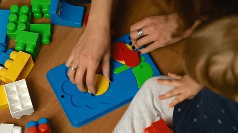 Child plays with designer kit on the floor, top view 库存影片 127761153