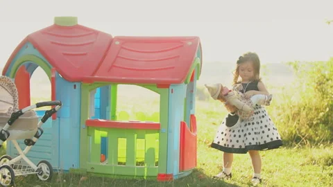 Child plays with a doll Video stock 128381696