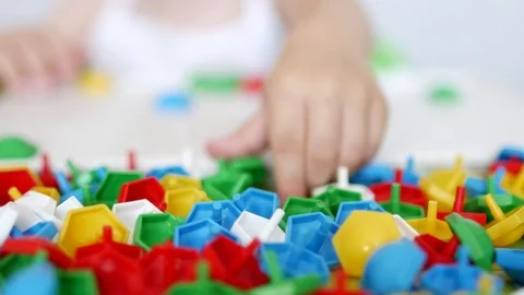 Child plays a game of developing motor skills, collect a designer multicolor Stock Footage 96461741