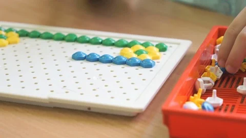 Child plays a intellectual game at a table Video stock 71778980