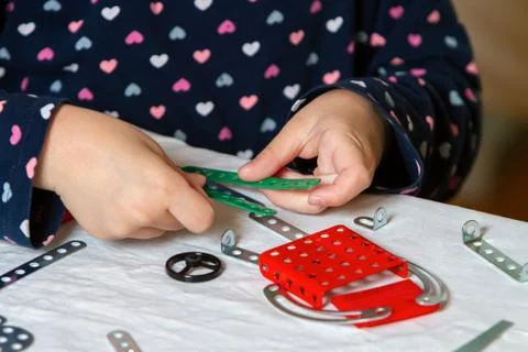 Child plays with iron constructor Stock Photos