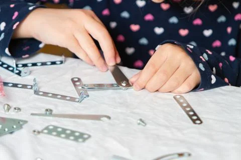 Child plays with iron constructor Stock Photos
