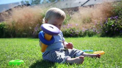A child plays on the lawn Stock Footage 137062465