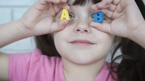 The child plays with the letters. Stock-Footage 103232071