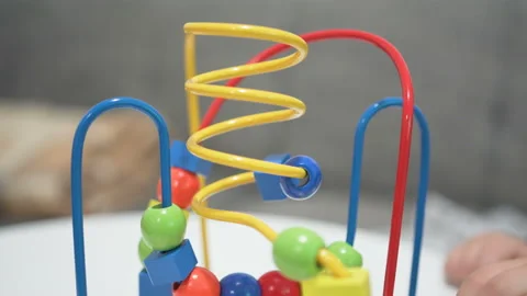 Child plays with a multi-colored toy. Close up hands Stock Footage 104036282