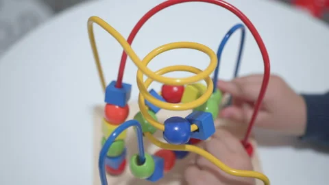 Child plays with a multi-colored toy. Close up hands Stock Footage 104038922