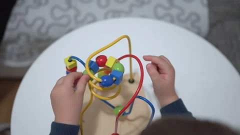Child plays with a multi-colored toy. Close up hands Stock Footage 104042114