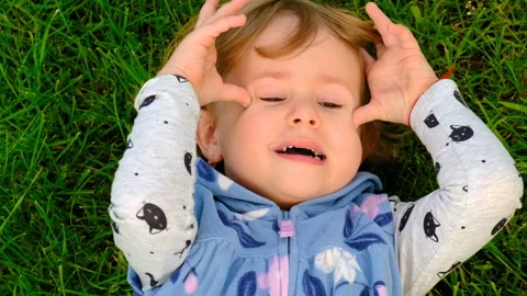Child plays in the park on the grass. Selective focus. Stock Footage 260374315