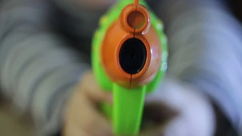 Child plays with a plastic gun Stock Footage 79413767