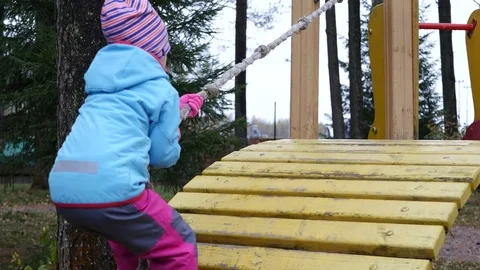 Child plays on playground.  Stockbeeldmateriaal 70392700