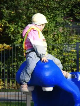 Child plays on playground Stock Photos