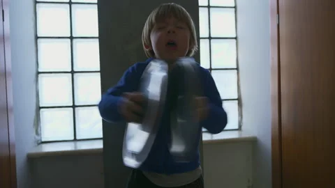 A child plays with pot lids Stock Footage 146313853