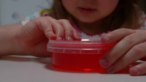 Child plays with red slime Stock Footage 129254485