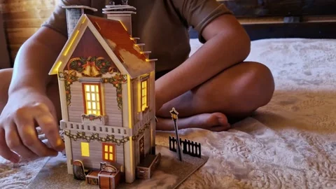 Child plays in room constructing toy house with joy Engrossed in play he build Stock Footage 266687250