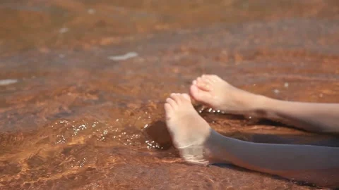 A child plays with sand on the beach Stock Footage 140507152