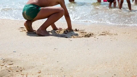 The child plays with sand on summer beach. Stock Footage 113703433
