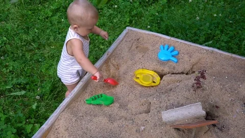 The child plays in the sandbox 스톡 동영상 79928245