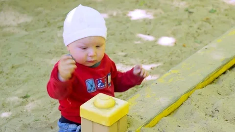 A child plays in a sandbox Stock Footage 90379625