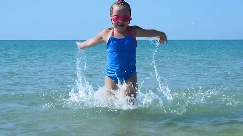 Child plays in the sea Stock Footage 79359612
