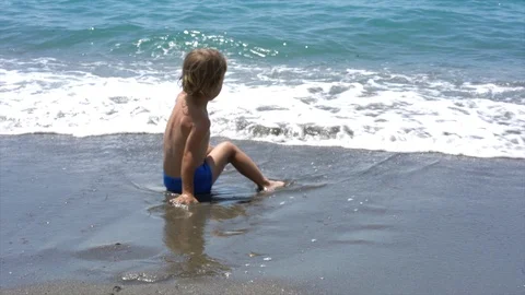 The child plays on the seashore Stock Footage 111691873