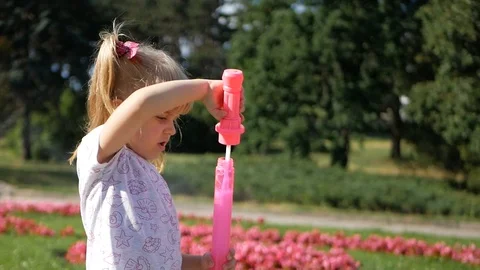 The child plays with soap bubbles in the Park. Video stock 95495122