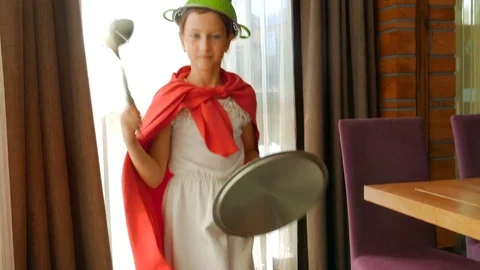 Child plays superheroes. Child play with kitchen utensils. Children's fantasy. Stock Footage 80304593