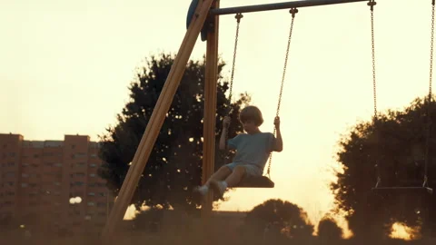 A child plays with the swing on the playground Stock Footage 255210913