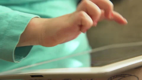 Child plays on a tablet device Video stock 158867116