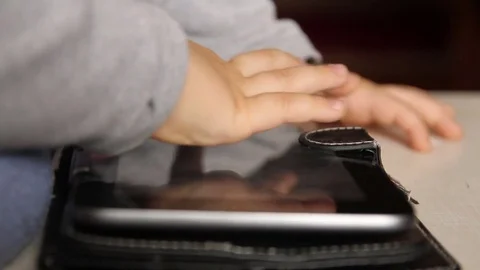 Child plays on the tablet Stock Footage 72768464